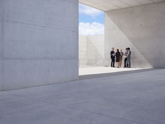 Besprechung einer Gruppe Architekten in einem Gebäude aus Beton